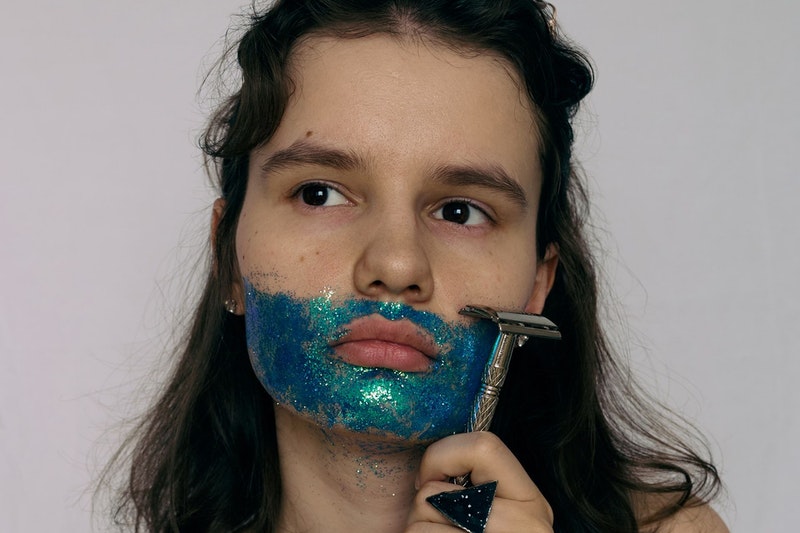 Frau rasiert sich glitzerndes Gesicht